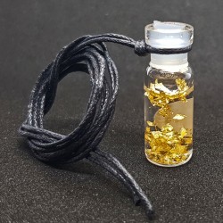 Small bottle with thin gold leaves, worn like pendant 